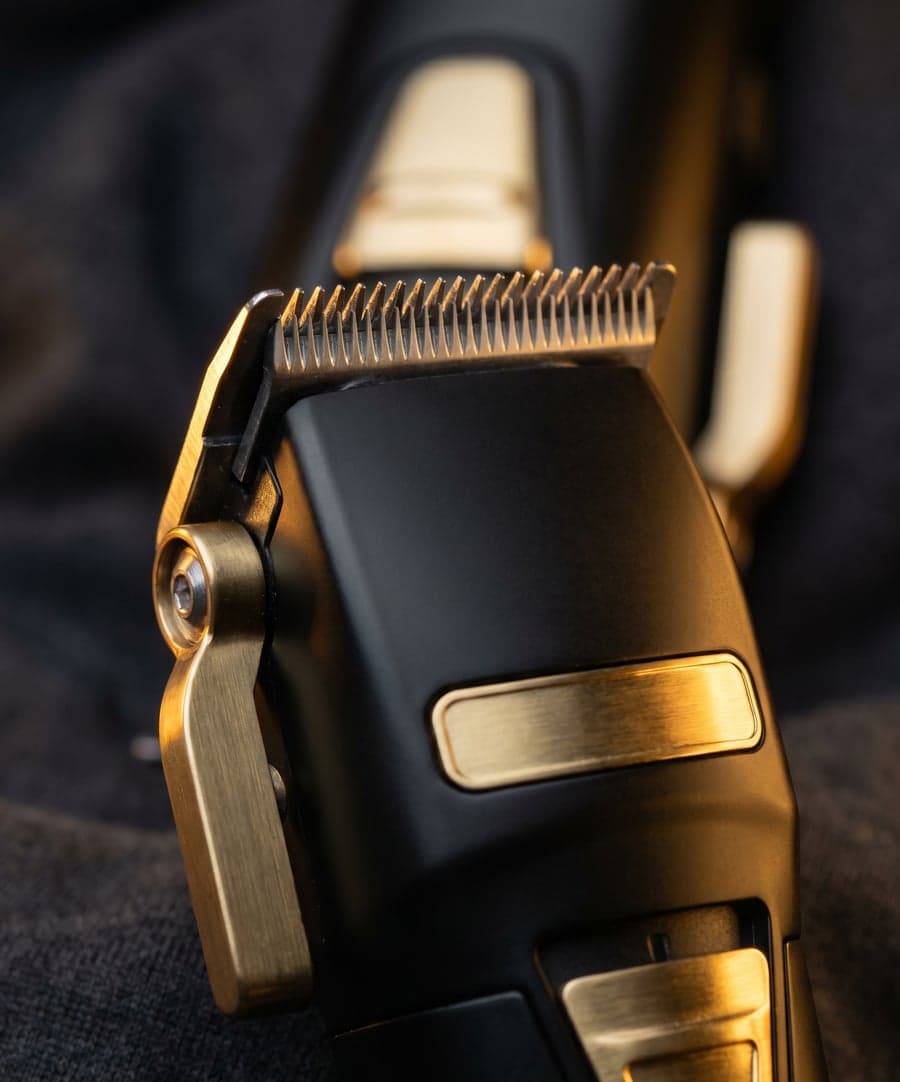 Professional trimmer with gold details, blade catching warm light